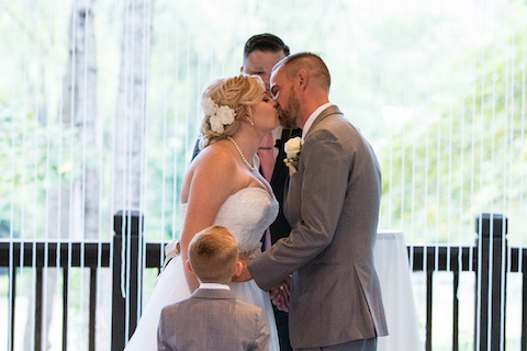 Bride and Groom kissing at wedding ceremony